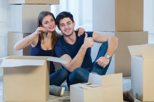 Movers handling a home move in London with boxes and furniture