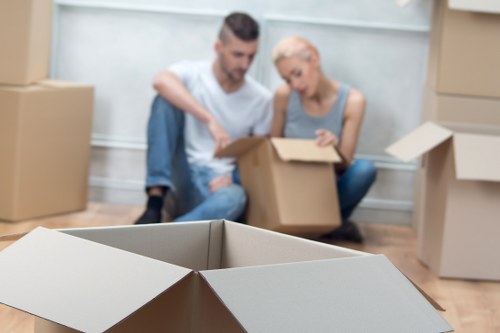 Professional movers handling furniture during a flat move in London