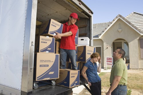 Local removals crew handling furniture in a London home
