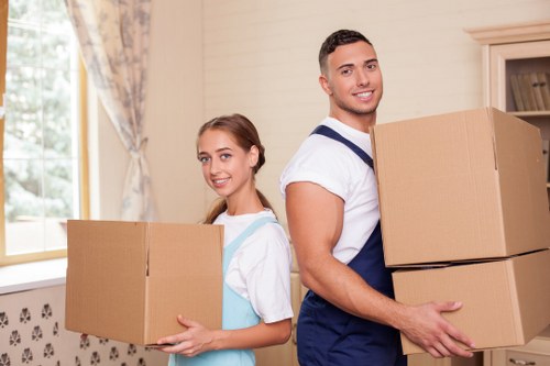 London flat move with boxes and furniture being carried to a moving truck