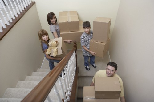 Mover carrying boxed items during a London relocation